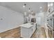 Large kitchen island featuring a quartz countertop and an open-concept design with stainless steel appliances at 407 Sandsend Ct, Apollo Beach, FL 33572