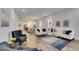Open-concept living room with modern furnishings, wood-look tile flooring, and ample natural light at 407 Sandsend Ct, Apollo Beach, FL 33572