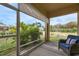 Relax on this screened patio featuring an outdoor seating area and views of the lush green yard at 407 Sandsend Ct, Apollo Beach, FL 33572