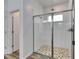 Modern shower with light tile and glass door at 407 Sandsend Ct, Apollo Beach, FL 33572