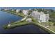 Scenic aerial view of waterfront condos with a pool, private beach, and lush landscaping at 4650 Bay Blvd # 1012, Port Richey, FL 34668