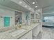 Bright bathroom featuring a double vanity, a large mirror, and access to a walk-in closet at 4650 Bay Blvd # 1012, Port Richey, FL 34668