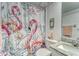 Bathroom featuring a toilet and vanity sink with a flamingo themed shower curtain at 4650 Bay Blvd # 1012, Port Richey, FL 34668