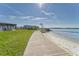 Scenic boardwalk leading to the private beach, offering serene waterfront views and easy access to the water at 4650 Bay Blvd # 1012, Port Richey, FL 34668