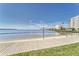 Community beachfront access with a sandy beach for relaxing, swimming, and enjoying the beautiful coastal scenery at 4650 Bay Blvd # 1012, Port Richey, FL 34668