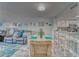 Charming dining area featuring a wicker table and chairs, complemented by coastal-themed decor at 4650 Bay Blvd # 1012, Port Richey, FL 34668