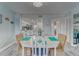 Dining room with an oval table, wicker chairs, and views to the kitchen at 4650 Bay Blvd # 1012, Port Richey, FL 34668