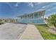 Exterior of the community center with light blue siding, white railings and staircase at 4650 Bay Blvd # 1012, Port Richey, FL 34668