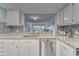 Modern kitchen with stainless steel appliances and a view of the living room and patio at 4650 Bay Blvd # 1012, Port Richey, FL 34668