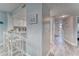 Open kitchen with white cabinets, barstool seating and a view of the entry and bedroom at 4650 Bay Blvd # 1012, Port Richey, FL 34668