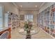 Community library featuring floor-to-ceiling bookshelves and cozy seating by a window, creating a perfect reading ambiance at 4650 Bay Blvd # 1012, Port Richey, FL 34668