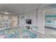 Cozy living area offering a dining table, TV, and doorway access to the Primary bedroom at 4650 Bay Blvd # 1012, Port Richey, FL 34668