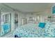 Bright bedroom with a nautical themed decor and sliding doors leading to a screened lanai at 4650 Bay Blvd # 1012, Port Richey, FL 34668