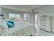 Serene bedroom boasts stunning water views, a plush bed, and access to the balcony at 4650 Bay Blvd # 1012, Port Richey, FL 34668