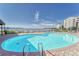 Beautiful pool overlooking the water with plenty of lounge chairs for relaxing at 4650 Bay Blvd # 1012, Port Richey, FL 34668