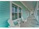 Enjoy rocking chairs on this screened-in porch, perfect for relaxing and soaking in the views at 4650 Bay Blvd # 1012, Port Richey, FL 34668