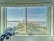 Stunning window view of the inter-coastal waterway with palm trees and a gazebo at 4650 Bay Blvd # 1012, Port Richey, FL 34668