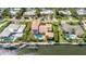 Aerial view of waterfront home with a private pool and dock with boating access at 520 74Th St, Holmes Beach, FL 34217