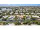 Real estate aerial view of a waterfront home with canal access surrounded by tropical greenery and other properties at 520 74Th St, Holmes Beach, FL 34217