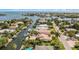 Beautiful neighborhood aerial view of the single-Gathering home with canal access and lush landscaping at 520 74Th St, Holmes Beach, FL 34217