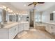 Inviting bathroom with dual vanities, a soaking tub, and updated finishes at 520 74Th St, Holmes Beach, FL 34217