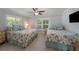 Twin beds with nautical themes, ceiling fan, and natural light at 520 74Th St, Holmes Beach, FL 34217