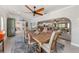 Open-concept dining room showcasing a rustic table and flow to the living spaces at 520 74Th St, Holmes Beach, FL 34217