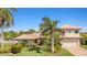 Beautiful home featuring a well-manicured lawn, charming landscaping, and a brick driveway at 520 74Th St, Holmes Beach, FL 34217