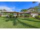 Beautiful two-story home showcasing lush landscaping and vibrant green lawn at 520 74Th St, Holmes Beach, FL 34217