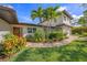 Inviting home featuring a well-manicured lawn and a charming walkway to the front door at 520 74Th St, Holmes Beach, FL 34217