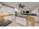 Large kitchen with stainless steel appliances, black counters, an island, and a ceiling fan at 520 74Th St, Holmes Beach, FL 34217