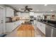 Bright kitchen with stainless steel appliances, black counters, and an island with butcher block at 520 74Th St, Holmes Beach, FL 34217