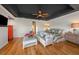 Comfortable bedroom boasts a sitting area, a king-sized bed, and modern ceiling fixtures at 520 74Th St, Holmes Beach, FL 34217
