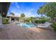 Private pool surrounded by lush landscaping, with an outdoor kitchen and lounge area at 520 74Th St, Holmes Beach, FL 34217