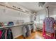 Well-lit walk-in closet with laminate wood flooring, shelving, and hanging rods at 520 74Th St, Holmes Beach, FL 34217