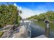 This waterfront scene shows the canal with dock, showcasing a tranquil setting with convenient water access at 520 74Th St, Holmes Beach, FL 34217