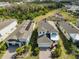 Aerial view showcases the home's roof, solar panels, well-manicured yard, and surrounding neighborhood at 5232 Wishing Arch Dr, Apollo Beach, FL 33572