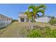 Backyard featuring a manicured lawn, white fence, and lush greenery perfect for outdoor activities and relaxation at 5232 Wishing Arch Dr, Apollo Beach, FL 33572