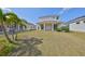Large backyard featuring a well-maintained lawn, and patio great for outdoor activities and relaxation at 5232 Wishing Arch Dr, Apollo Beach, FL 33572