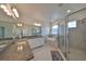 Bright bathroom with double vanity, soaking tub, and glass-enclosed shower offering a spa-like experience at 5232 Wishing Arch Dr, Apollo Beach, FL 33572