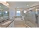 Beautiful primary bathroom featuring dual sinks, a soaking tub, and a glass-enclosed shower at 5232 Wishing Arch Dr, Apollo Beach, FL 33572