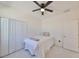 Well-lit bedroom featuring carpet, closet, and ceiling fan at 5232 Wishing Arch Dr, Apollo Beach, FL 33572