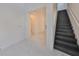 Entry hall with black stairs and marble flooring at 5232 Wishing Arch Dr, Apollo Beach, FL 33572