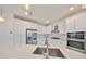 Modern kitchen with stainless steel appliances, white cabinets, and quartz countertops at 5232 Wishing Arch Dr, Apollo Beach, FL 33572