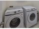 Laundry room with modern Samsung washer and dryer units at 5232 Wishing Arch Dr, Apollo Beach, FL 33572