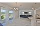 Living area features a blue sectional, marble floors, and sliders to the outdoor space at 5232 Wishing Arch Dr, Apollo Beach, FL 33572