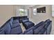 Large blue sectional in the open living area of this home, with sliders to the outdoor space at 5232 Wishing Arch Dr, Apollo Beach, FL 33572