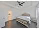 Luxurious main bedroom boasts a tray ceiling, a decorative bed frame, and dark hardwood floors at 5232 Wishing Arch Dr, Apollo Beach, FL 33572