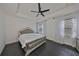 Luxurious main bedroom with a decorative bed frame, dark hardwood floors, and natural lighting at 5232 Wishing Arch Dr, Apollo Beach, FL 33572
