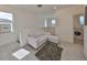 Upstairs sitting area with cozy white couch, plush rug, and laundry access at 5232 Wishing Arch Dr, Apollo Beach, FL 33572